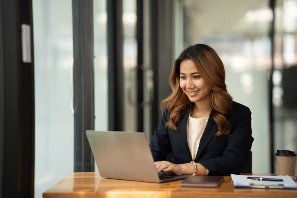 Asian woman working with laptop in her office. business financia
